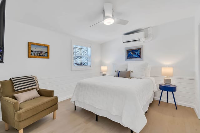 Main bedroom with queen bed with calm blue accents and comfortable bedding.