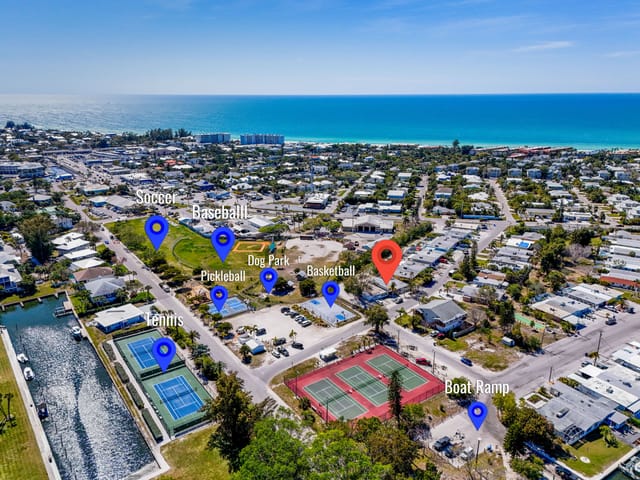 Red marker is where the home is located just a minute walk from tennis and pickleball courts and a playground and a boat