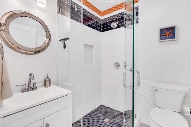 Coastal inspired bathroom with walk in glass enclosed shower