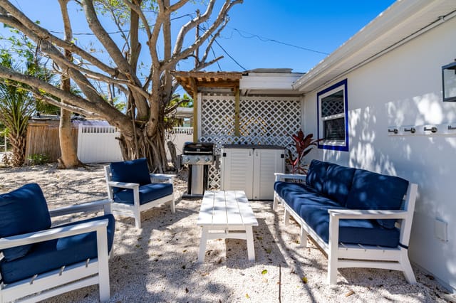 Outdoor seating on peaceful back patio area with the sounds of birds in the trees nearby. Even green parrots are sometim