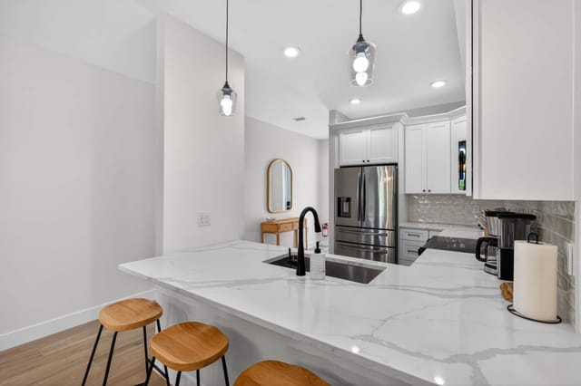 Open hallway leading straight into a beautifully furnished kitchen with lots of space to host and have company