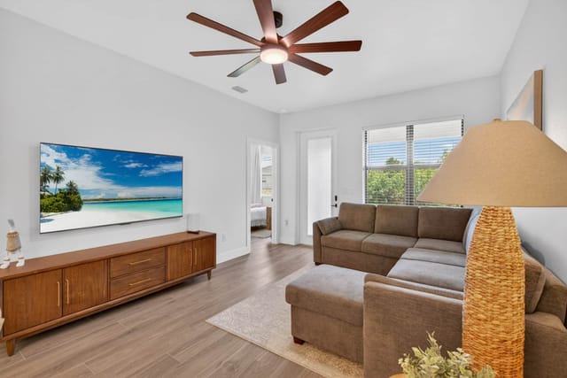 Cozy coastal living room with space on the couch for everyone along with a full sized pull-out bed