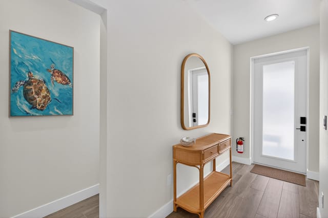 Coastal and airy foyer with wicker textures and space for shoes and keys