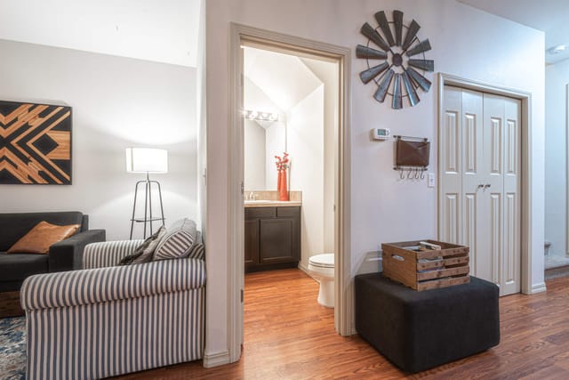Main level with 1/2 bathroom next to kitchen, living room, and dining room