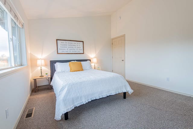 Master bedroom with high ceilings, comfortable queen mattress, and high quality linens