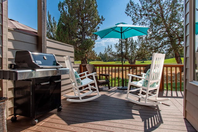 BBQ with comfortable outdoor furniture and stunning greens view.