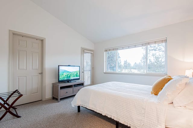 Master bedroom with queen bed and luxurious linens