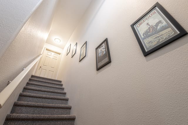 Carpeted stairway to second floor has Oregon memorabilia decorations