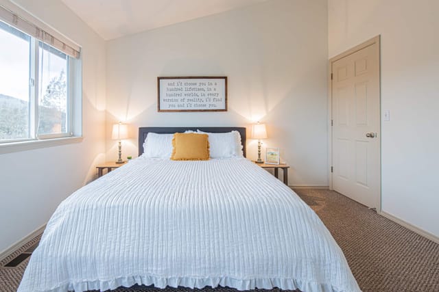 Master bedroom looking out onto 9th fairway of the golf course with private deck