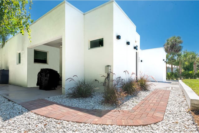 Side entrance with brick pavers, plenty of area to sit and enjoy shaded area of the house