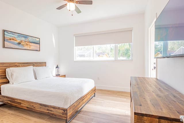 2nd Master - bedroom with natural wood details and plenty of storage. Plush bedding ready for a great night's sleep.