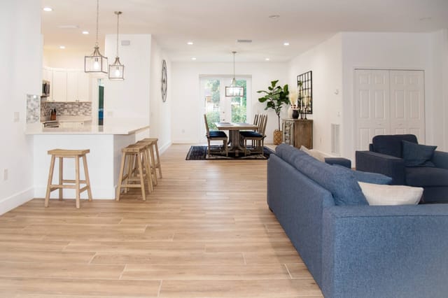 Spacious modern living and dining areas adjacent to a kitchen that's perfect for entertaining with seating to fit everyo