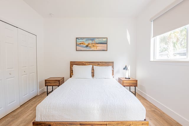 Second master bedroom with coastal accents and blackout curtains for restful sleep.