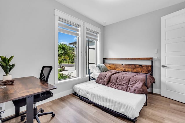 Office area with standing desk for all your work needs along with comfortable twin sleeping area