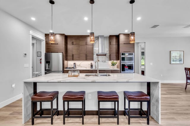 Modern-styled kitchen with lots of counter space stocked with coffee and mugs