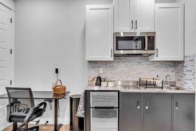 Minimalist style kitchen with necessary appliances and an area to do your work with a standing desk