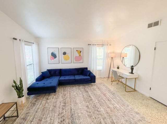 Nicely decorated entry area with large couch and work desk for those quick email replies.