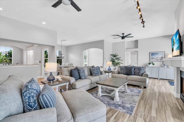 Beach-inspired living room with lots of natural light and gas fireplace