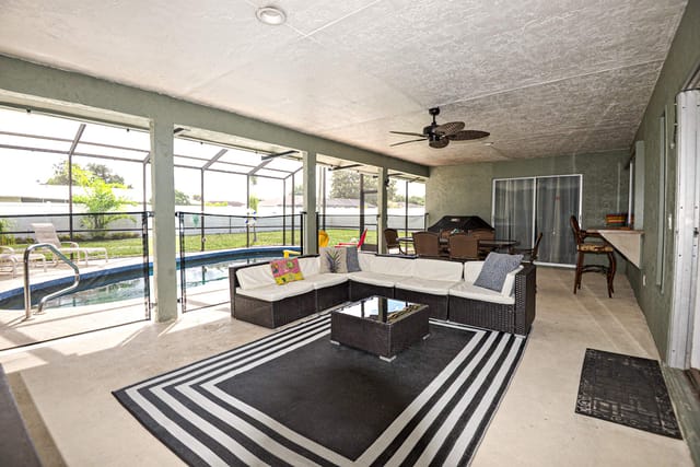Outdoor seating for 6 next to a BBQ grill and beautiful pool POOL FENCE for additional Safety (retractable)